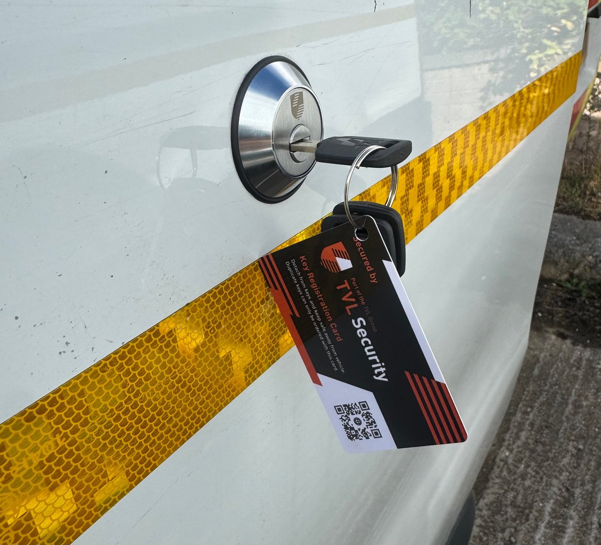 TVL Security van slamlock fitted to a white commercial van door with yellow reflective strip and registration card